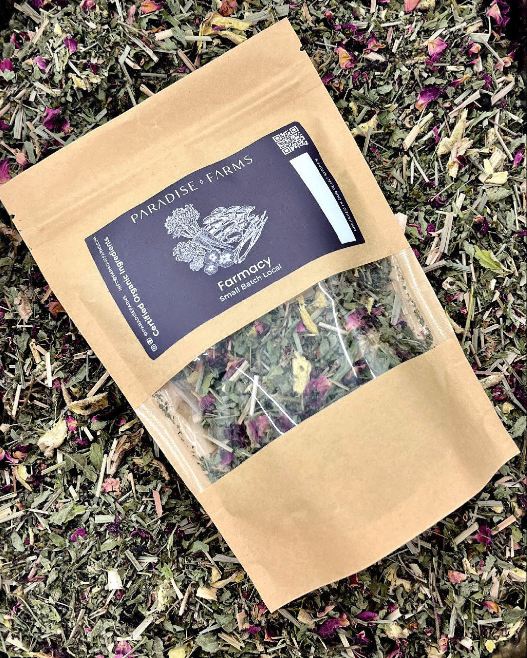 Paradise Farms tea package on a bed of loose tea leaves