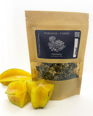 A packaged tea blend named Shooting Star Tea with pieces of starfruit in front of the package.