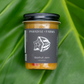 Jar of Paradise Farms starfruit jam on a green leaf background